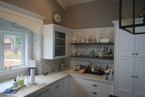 Glass fronted cabinets with reclaimed shelves